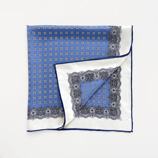 a cerulean blue square silk scarf with white base and navy blue hand-rolled hems, featuring boho style print