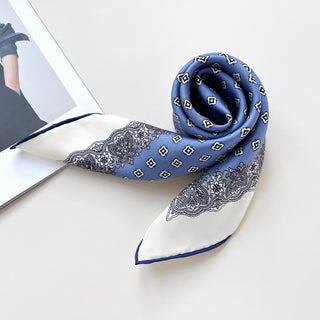 a cerulean blue square silk scarf with white base and navy blue hand-rolled hems, featuring boho style print