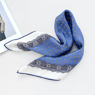 a cerulean blue square silk scarf with white base and navy blue hand-rolled hems, featuring boho style print