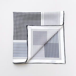 a black and white square silk scarf with black hand-rolled hems featuring classic houndstooth and checks print