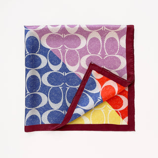 a luxury square silk scarf in lilac oink, blue, orange and yellow featuring burgundy hand-rolled edges and classic print