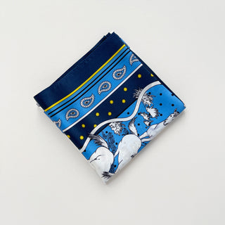 a bright blue men's silk scarf featuring classic horse riding and paisley prints with navy blue edge