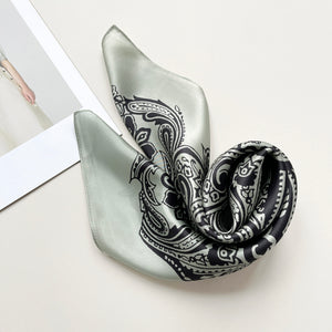 a pale pea green silk scarf with black boho style print