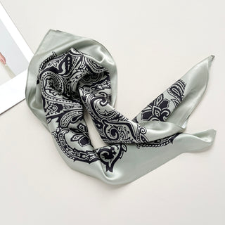 a pale pea green silk scarf with black boho style print