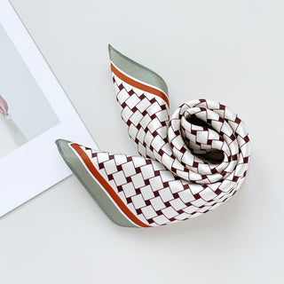 a white base pinted silk bandana scarf with pea green and orange edge, featuring burgundy geometric block print