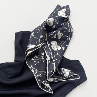 a black and white rose print silk scarf with handmade edges, paired with a black dress