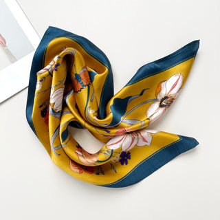 vintage vibe silk bandana scarf in vibrant mustard yellow featuring flowers and butterflies print with dark blue edge