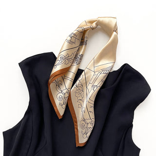 53x53cm silk bandana for women featuring a pale apricot base with intricate black architectural illustrations and a brown border. This elegant women's silk scarf adds a touch of luxury and sophistication to any outfit.