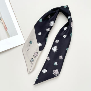 a luxury floral rose black silk scarf with beige edge, featuring hand-rolled hems, tied as a hair ponytail 