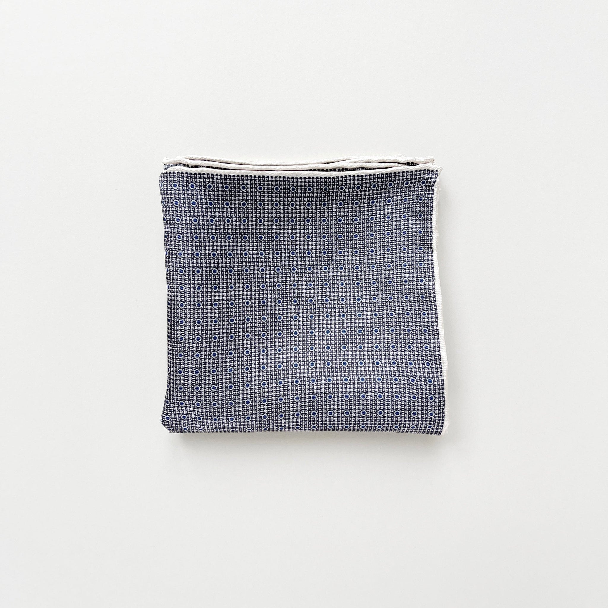a classic silk scarf neckerchief featuring black and white checks and navy blue polka dots with white hand-rolled hems