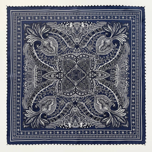 a navy blue silk bandana scarf featuring white and black symmetric pattern with striped hand-rolled edges