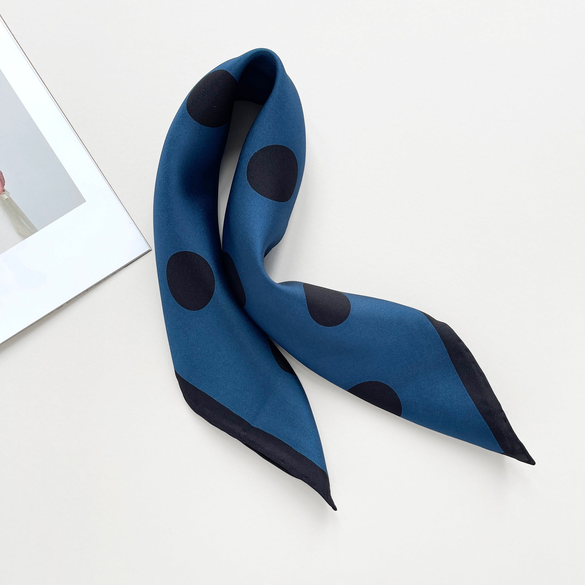 a Yale blue silk bandana scarf featuring black polka dots print