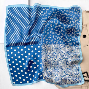 a blue silk bandana scarf featuring white paisley and polka dot pattern