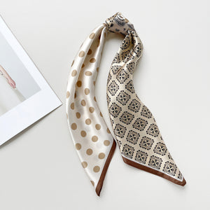 a beige and brown earth tones silk scarf featuring bohemian paisley and polka dot prints with brown edges, knotted as a ponytail head scarf