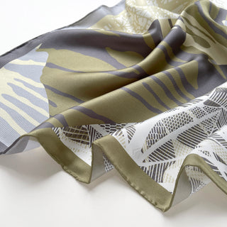 a forest leafy printed square silk scarf in sage green, grey and white tones with hand-rolled edges