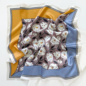 a women's silk scarf bandana featuring white rock roses print with cornflower blue and orange edges