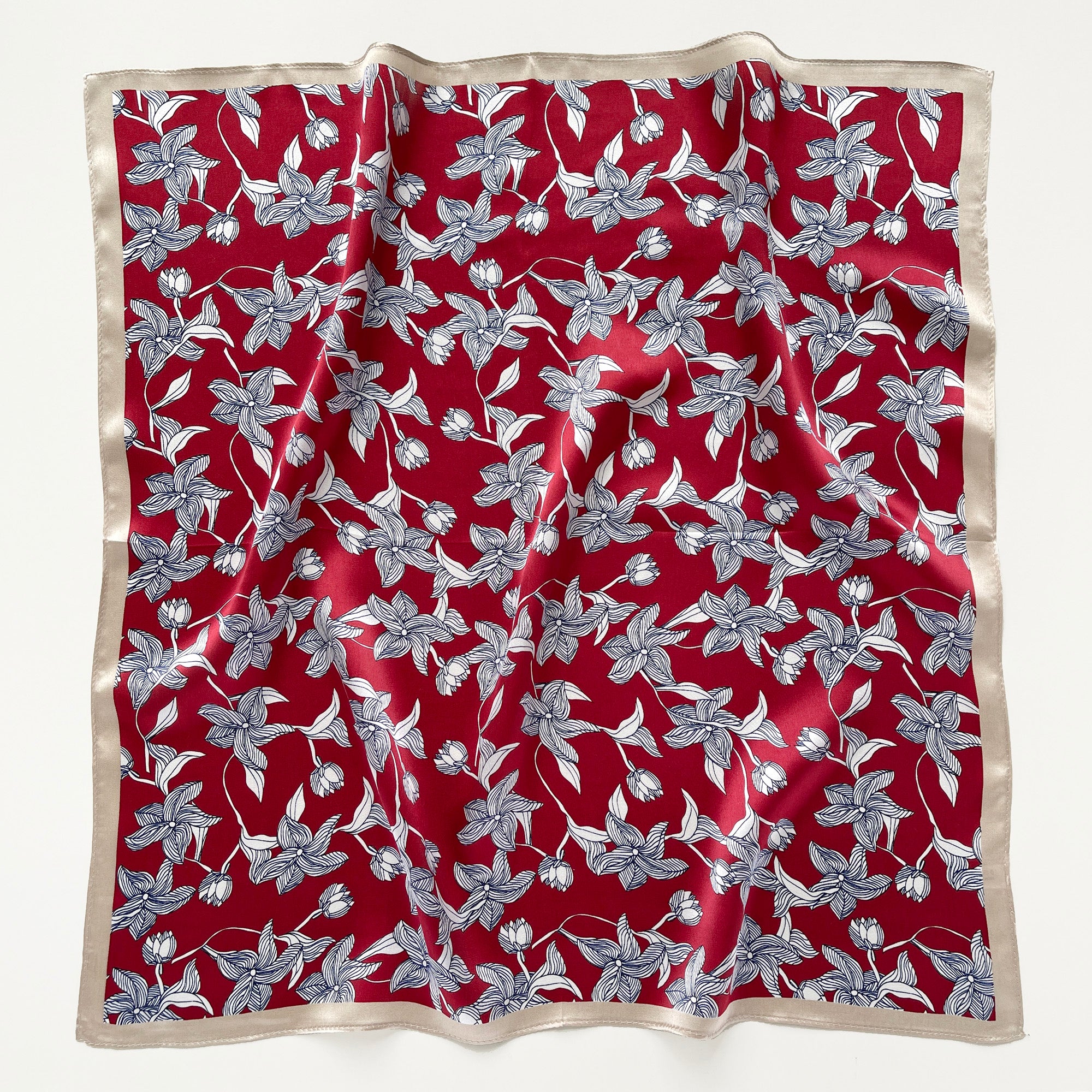 a burgundy red silk bandana scarf featuring floral print with light beige edge
