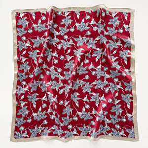 a burgundy red silk bandana scarf featuring floral print with light beige edge