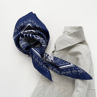 Navy blue silk bandana with vintage carriage and wheel print, featuring white polka dots and intricate hand-rolled hems. Unisex design made from 100% silk twill, perfect as a neckerchief or versatile accessory.