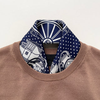 Navy blue silk bandana with vintage carriage and wheel print, featuring white polka dots and intricate hand-rolled hems. Unisex design made from 100% silk twill, perfect as a neckerchief or versatile accessory.