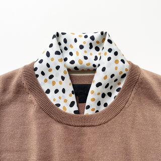 Timeless square silk scarf for men and women featuring a Dalmatian-inspired dot pattern in black and beige on a white background, with a black and beige striped border and hand-rolled edges