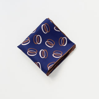 Indigo purple unisex silk bandana scarf with a circular pattern, made from 100% silk twill, featuring hand-rolled edges. The scarf measures 53x53cm and is designed for both men and women.