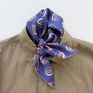 Indigo purple unisex silk bandana scarf with a circular pattern, made from 100% silk twill, featuring hand-rolled edges. The scarf measures 53x53cm and is designed for both men and women.