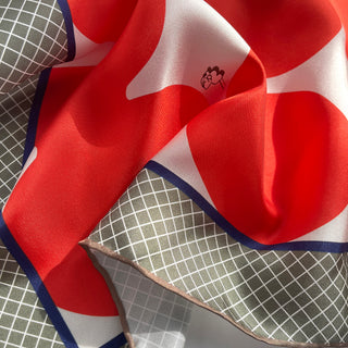 an orangey red geometric print silk scarf/bandana/neckerchief/square with hand rolled hems