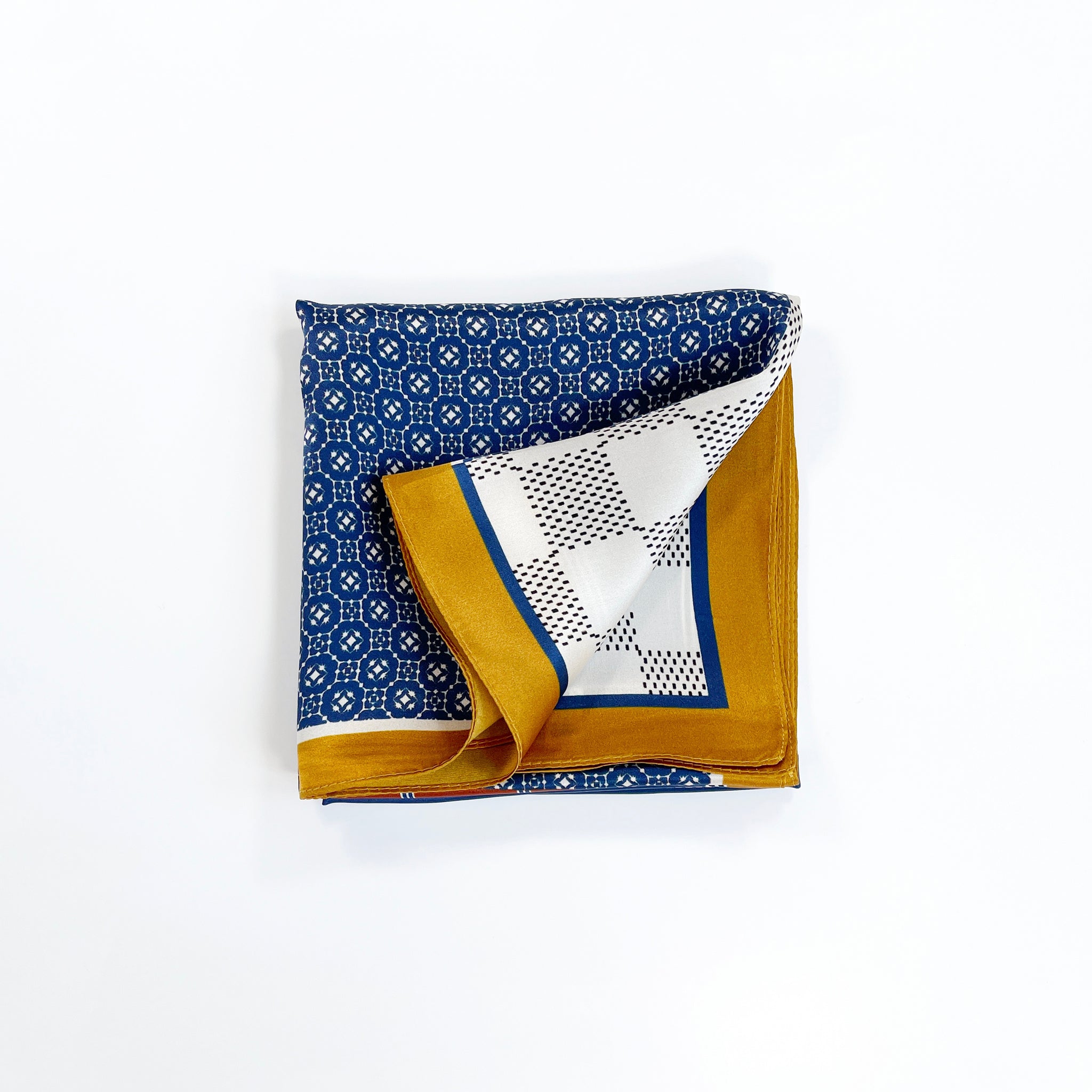 a unisex silk scarf with geometric pattern in navy blue, white and mustard yellow 