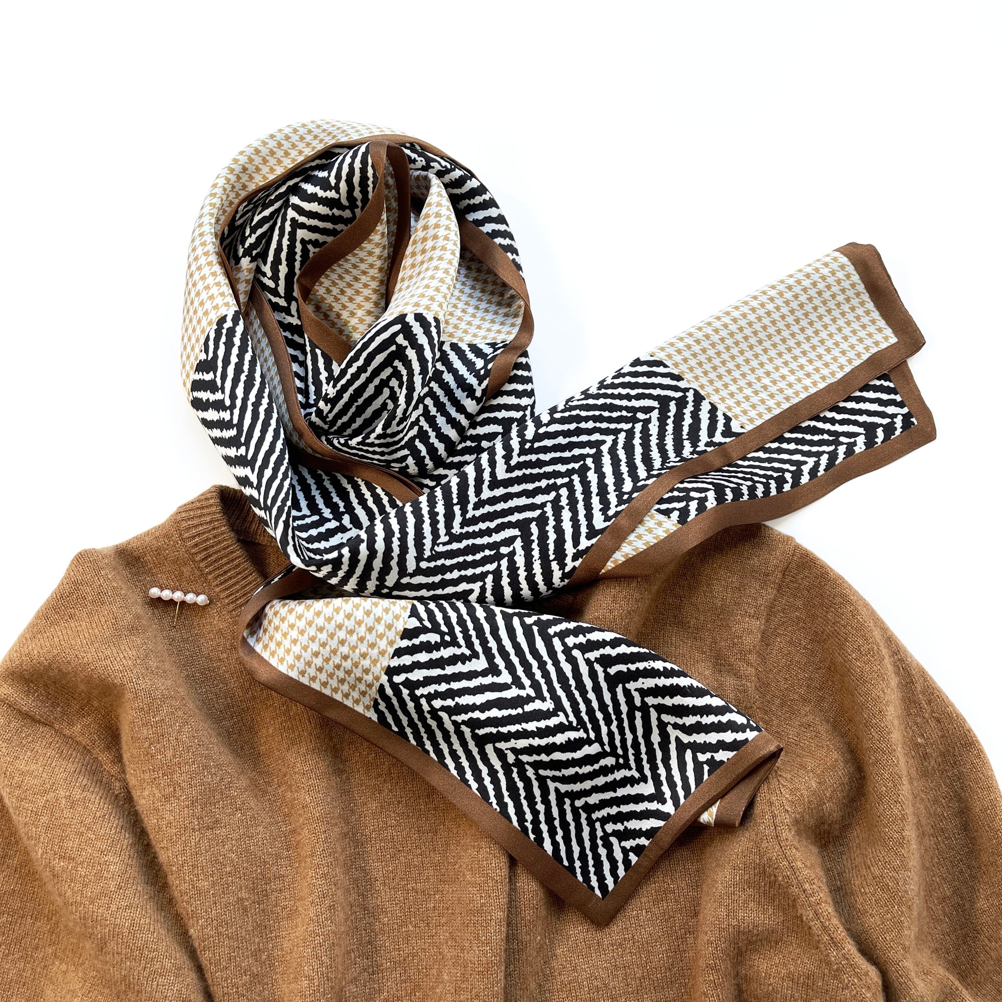 a houndstooth and zebra line pattern long silk scarf in beige, taupe and black palette palette