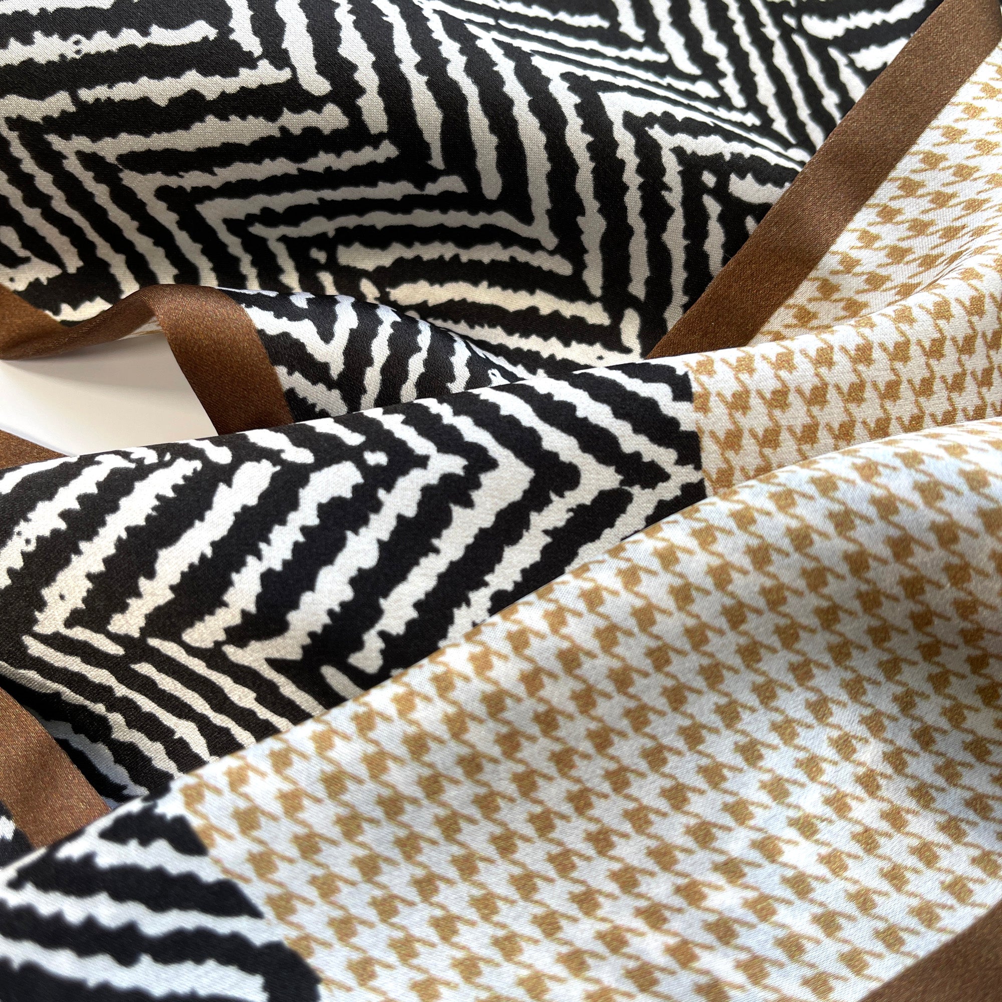 a houndstooth and zebra line pattern long silk scarf in beige, taupe and black palette palette