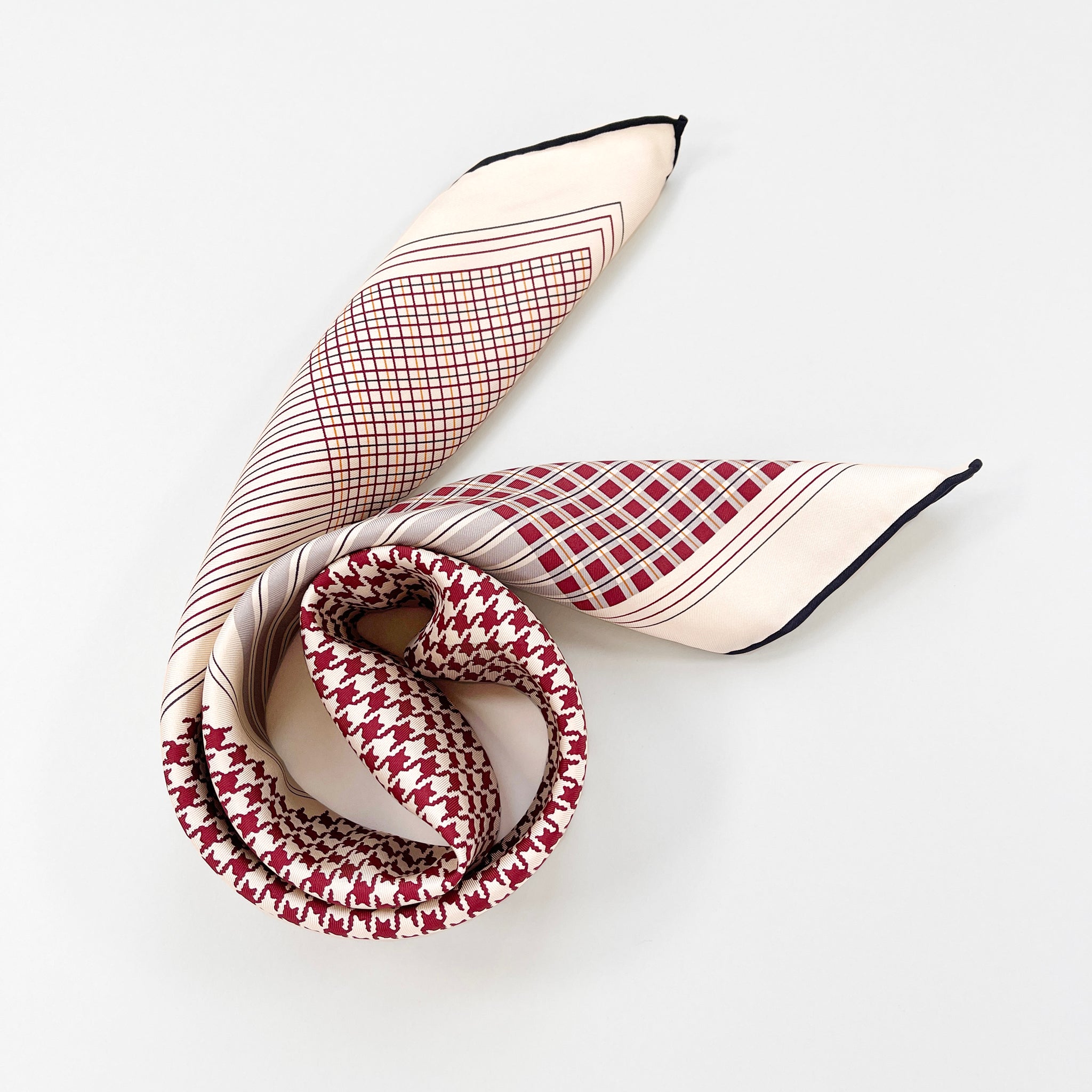a deep red houndstooth pattern square silk scarf with hand-rolled hems