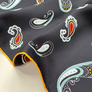 a black square silk scarf with boho paisley pattern and hand-rolled hems