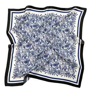 a white based square silk scarf with rich blue paisley pattern print featuring black edge suits for both women and men