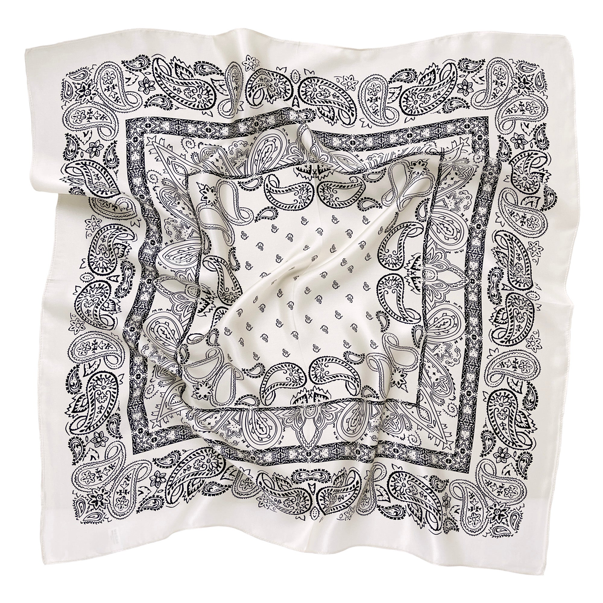 a light beige square silk scarf featuring black paisley print
