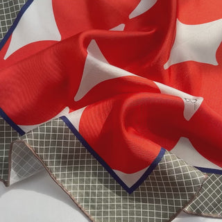 an orangey red geometric print silk scarf/bandana/neckerchief/square with hand rolled hems