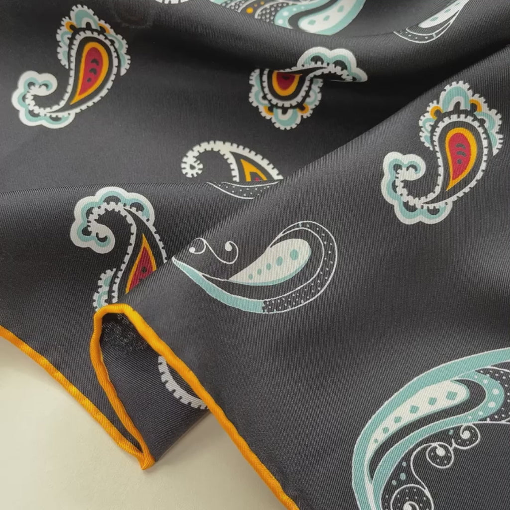 a black square silk scarf with boho paisley pattern and hand-rolled hems