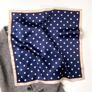 a navy blue small silk scarf/neckerchief with polka dot pattern