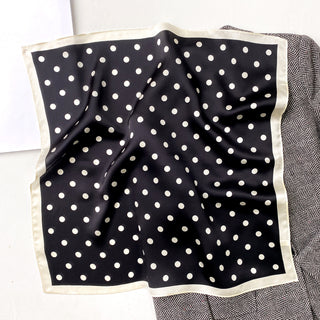 a black small silk scarf/neckerchief with polka dot pattern