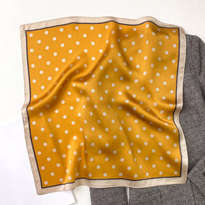 a mustard yellow small silk scarf/neckerchief with polka dot pattern  Edit alt text