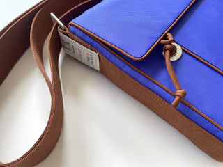 Recycled indigo blue preppy style messenger bag with brown strap