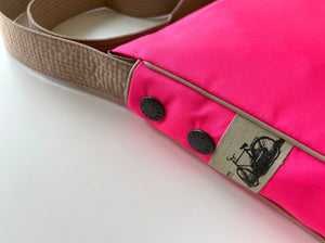 a neon pink recycled crossbody bag