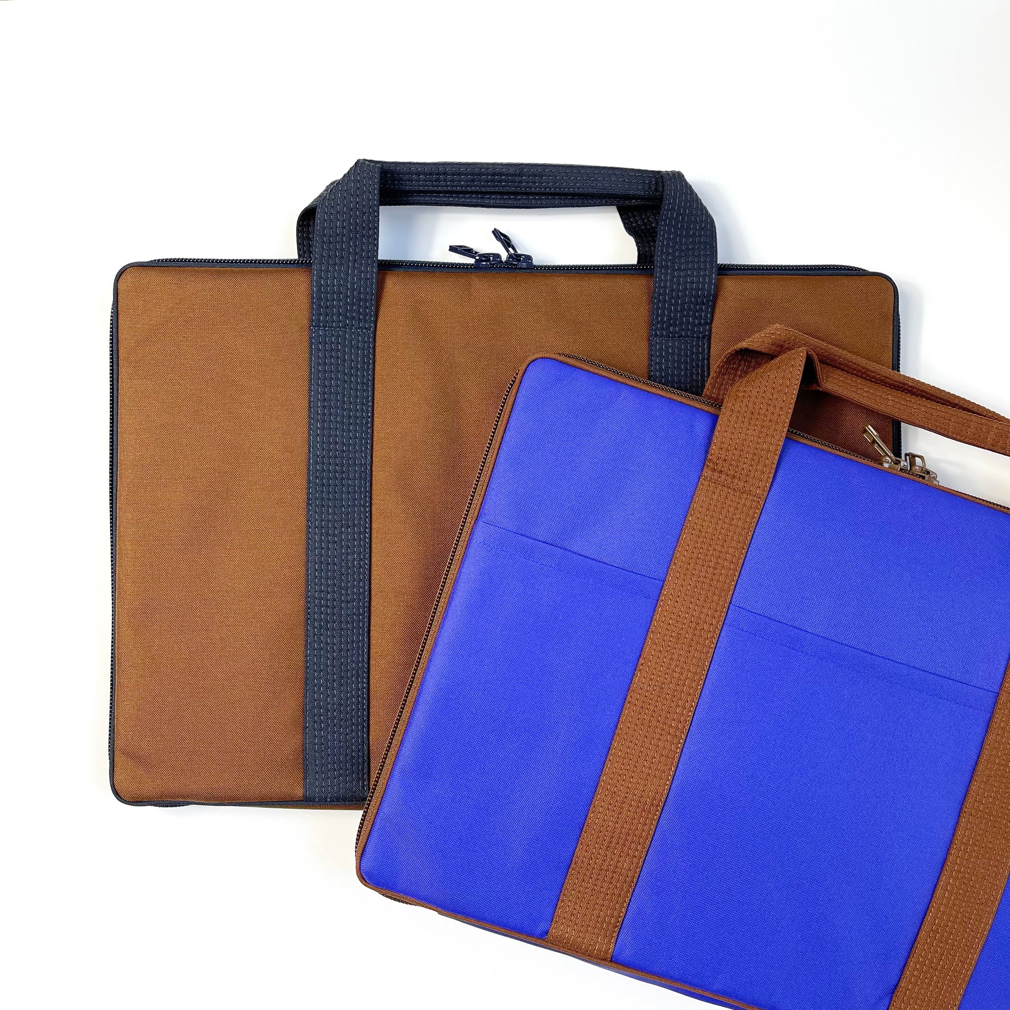 two recycled laptop briefcases in brown and indigo blue