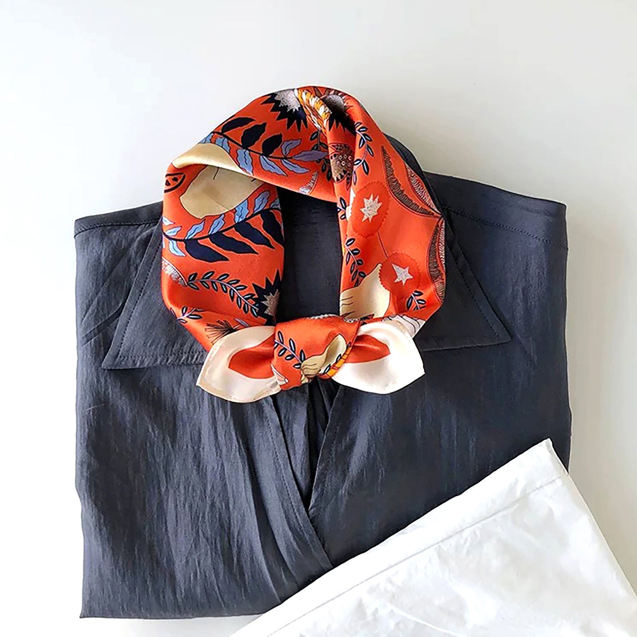an orange small silk scarf/bandana/neckerchief with tarot print