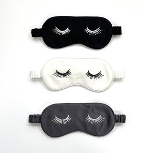 three silk eye masks featuring eyelashes embroidery and elastic strap in black, white and grey