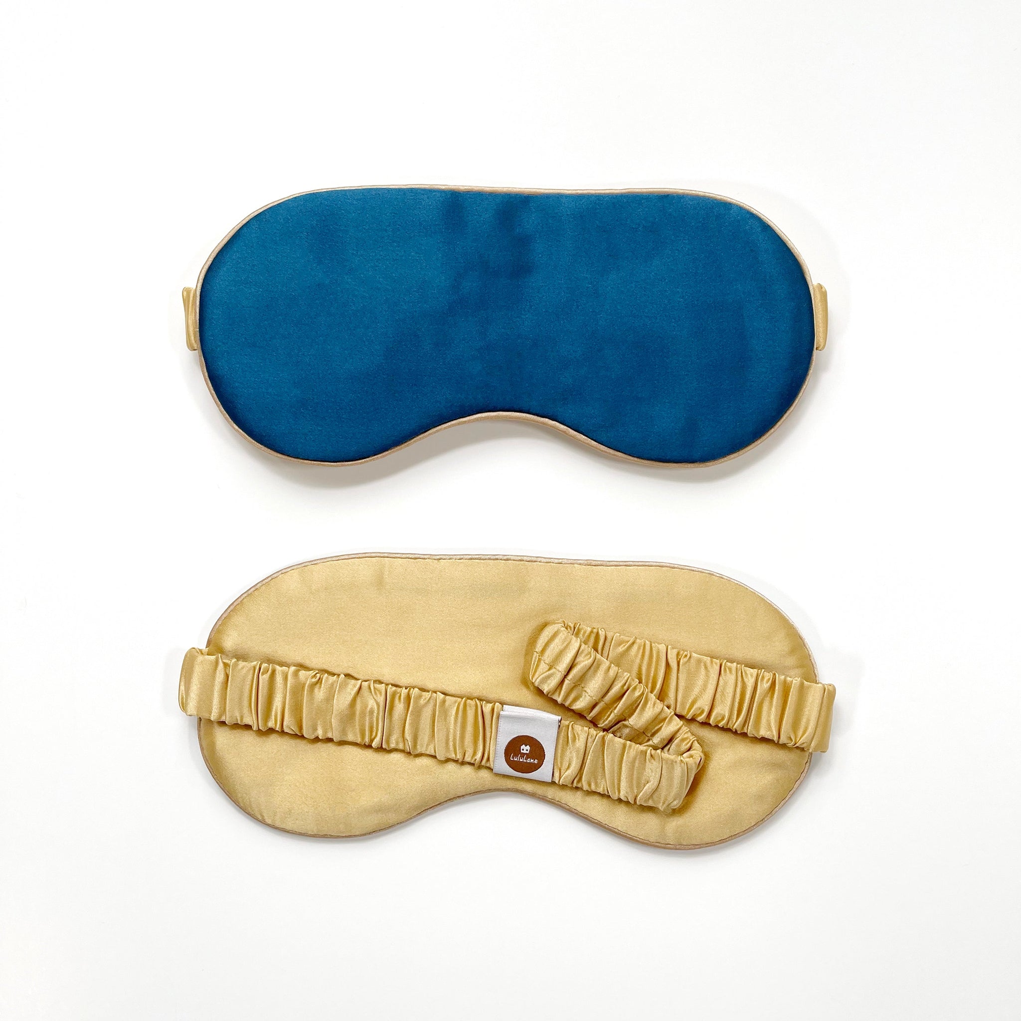 a blue silk eye mask with light golden strap and back side