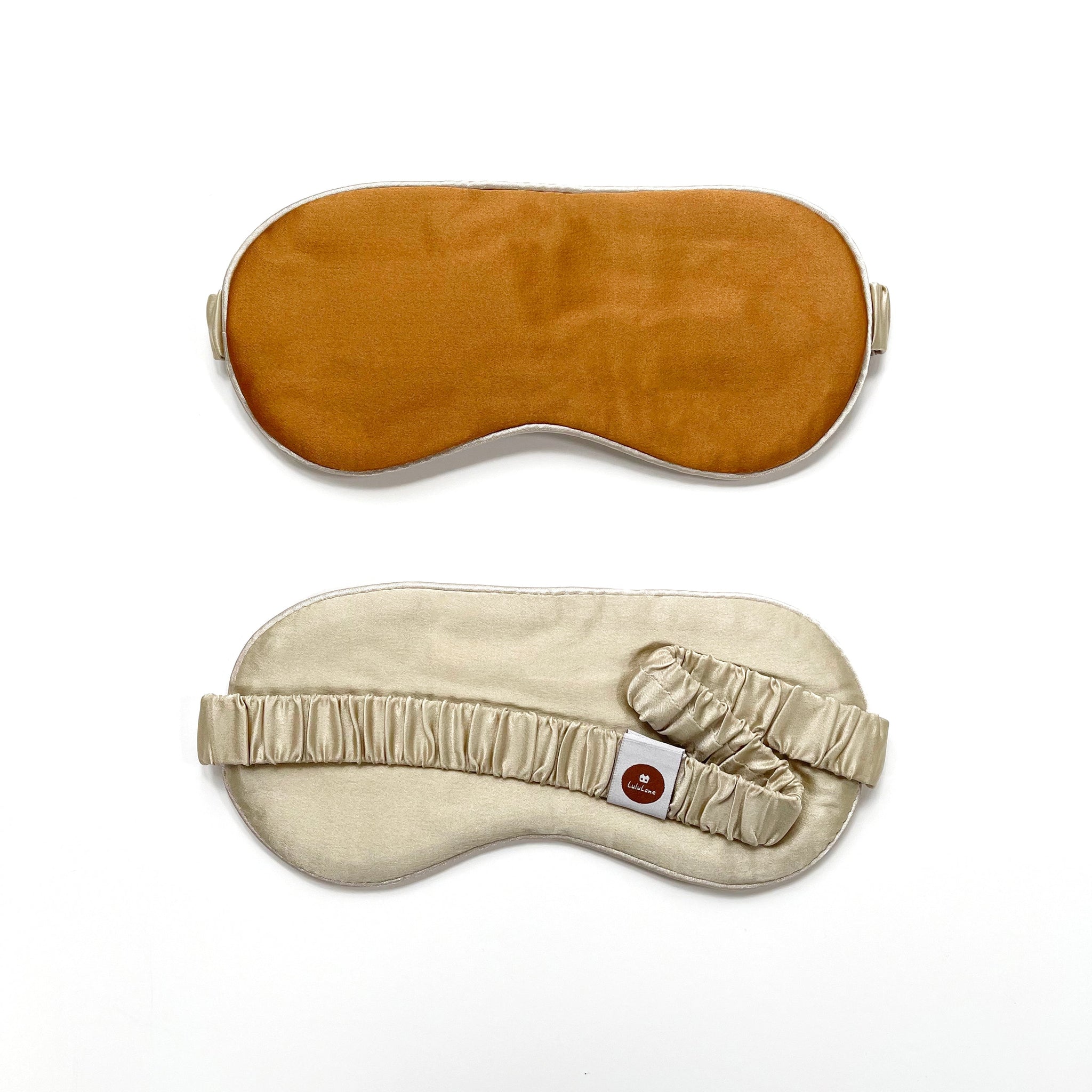 a bronze silk eye mask with light beige strap and back side