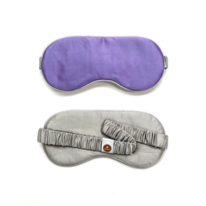 a purple silk eye mask with grey strap